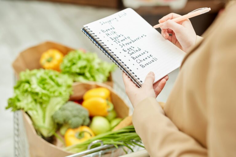 Woman Holding Shopping List in Supermarket